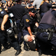 Protesters struggle with police after trying to burn an American flag near the site of the Republican National Convention in downtown Cleveland on the third day of the convention, July 20, 2016.
Spencer Platt/Getty Images